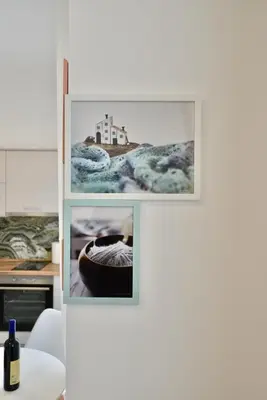 a white wall with three pictures on it at TriA Studio in Bar