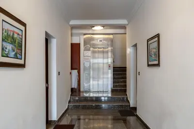 a hallway of a hotel with stairs and a elevator at Net in Rafailovici