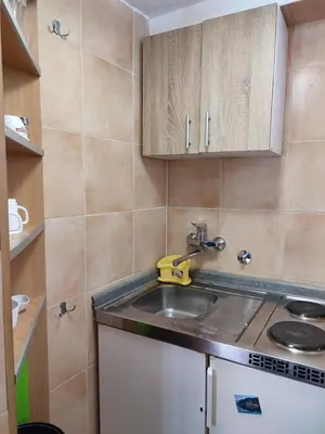 a small kitchen with a sink and a counter at Bay Mola Home in Kotor