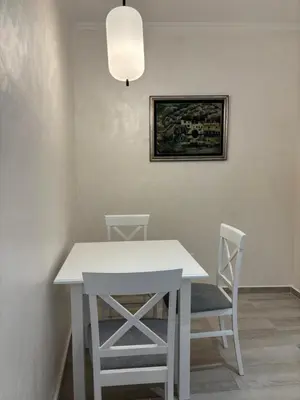 a white table and two chairs in a room at Petar Apartment in Podgorica