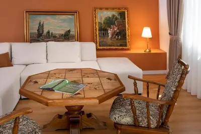 a living room with a table and a couch at Classy & Central Apartment David (parking included) in Virpazar