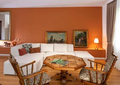 a living room with a white couch and a table at Classy & Central Apartment David (parking included) in Virpazar