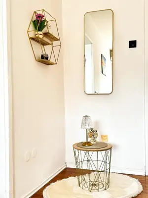 a room with a round table and a mirror at Mia Apartment in Budva