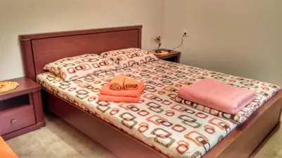 a bedroom with a large bed with two pillows at Rooms Dujeva Drago-Resort in Rijeka Crnojevića