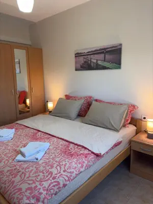 a bedroom with a large bed with two towels on it at Rooms Dujeva Drago-Resort in Rijeka Crnojevića