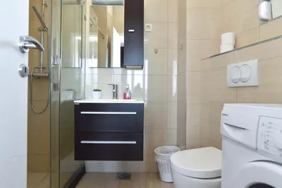 a bathroom with a sink and a toilet and a shower at Apartments Jelušić in Budva