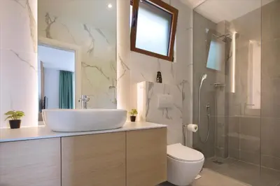 a bathroom with a sink and a toilet and a shower at Villa Fotinia in Budva