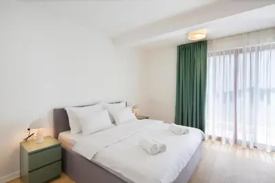 a bedroom with a large bed with two towels on it at Villa Fotinia in Budva