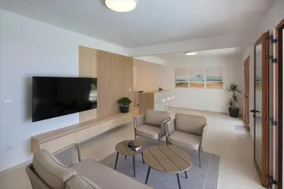 a living room with a couch and chairs and a tv at Villa Fotinia in Budva