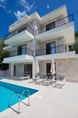 a villa with a swimming pool and a building at Villa Fotinia in Budva