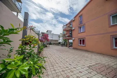 a cobblestone alley between two buildings with flowers at Apartment Marcic in Bar