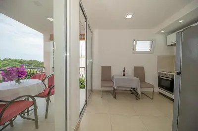 a kitchen and dining room with a table and chairs at Apartment Marcic in Bar