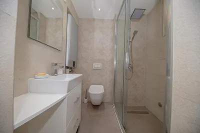 a bathroom with a shower and a sink and a toilet at Apartment Marcic in Bar