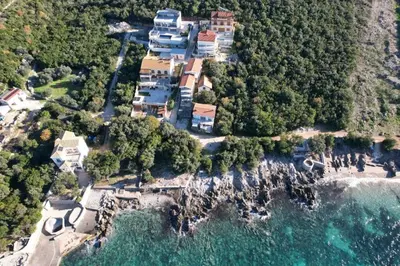 an aerial view of a house on a cliff next to the ocean at Luxury Villa Pontus in Kotor