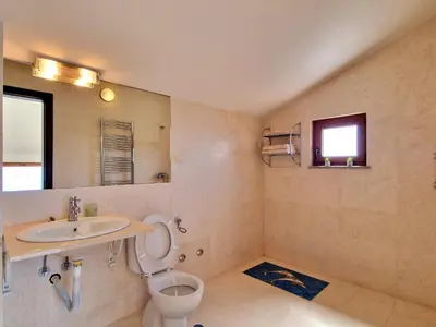 a bathroom with a toilet and a sink at Luxury Villa Pontus in Kotor