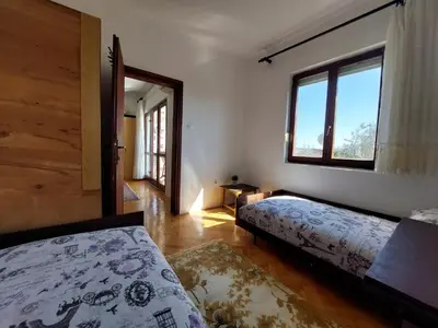 a bedroom with two beds and a window at PEKOVIĆ in Bar