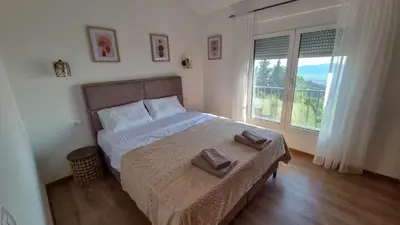 a bedroom with a bed with two towels on it at Olive Grove in Bar