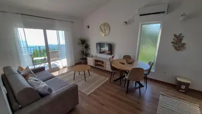 a living room with a couch and a table at Olive Grove in Bar