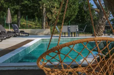 a basket in front of a swimming pool at Olive Grove in Bar