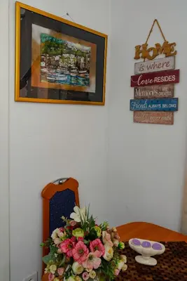 a table with a bouquet of flowers on it at Vila apartment Astorija 2 in Podgorica