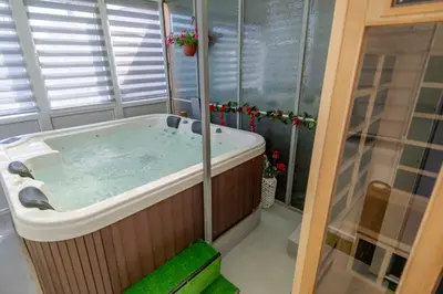 a bathroom with a hot tub in a room at Vila apartment Astorija 2 in Podgorica