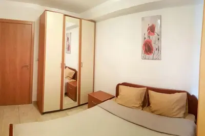 a living room with a couch and a mirror at Apartment with a garden Petrovac in Petrovac na Moru