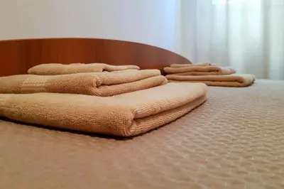 a group of towels sitting on top of a bed at Apartment with a garden Petrovac in Petrovac na Moru
