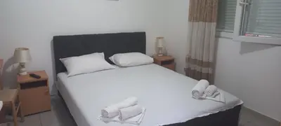 a bedroom with a white bed with shoes on it at MICIC CENTRE in Budva
