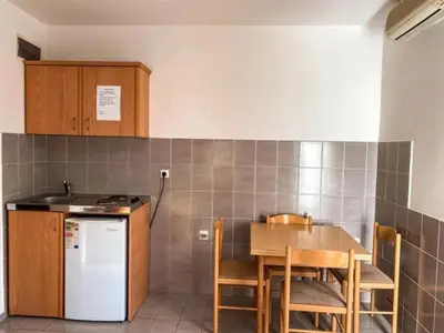 a kitchen with a table and chairs and a refrigerator at MICIC CENTRE in Budva