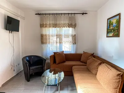 a living room with a couch and a glass table at MICIC CENTRE in Budva
