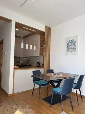 a dining room and kitchen with a table and chairs at LUX Apartment Secret Residence in Becici
