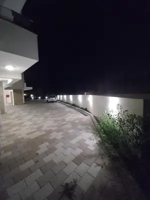 an empty parking lot at night with lights at LUX Apartment Secret Residence in Becici