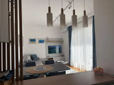 a living room with a table and a couch at LUX Apartment Secret Residence in Becici