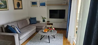 a living room with a couch and a table at LUX Apartment Secret Residence in Becici