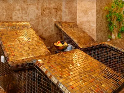 three benches with a bowl of fruit in a room at Tecasi Lux Apartments in Budva