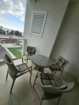 a patio with a table and chairs and a window at Tecasi Lux Apartments in Budva