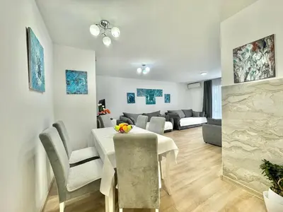 a dining room and living room with a table and chairs at Family One bedroom apartment Marijana in Budva