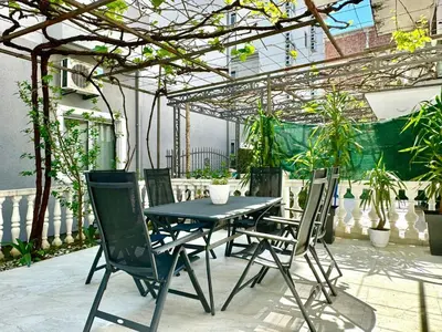 a black table and chairs on a patio at Family One bedroom apartment Marijana in Budva