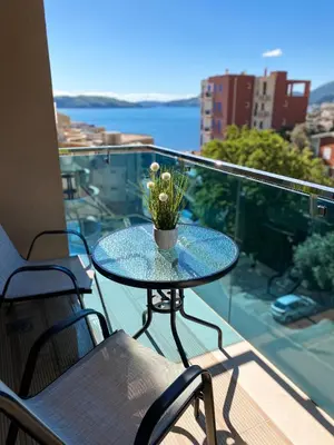 a glass table with a plant on a balcony at Vanja apartment Przno in Budva