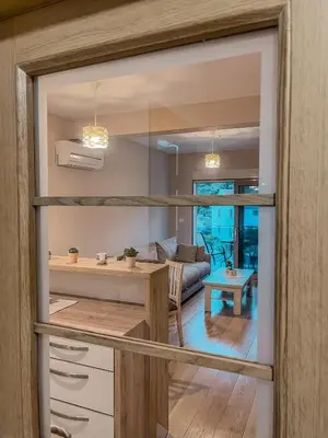 a kitchen and living room with a view of the living room at Vanja apartment Przno in Budva