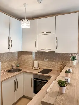 a kitchen with white cabinets and a sink at Vanja apartment Przno in Budva
