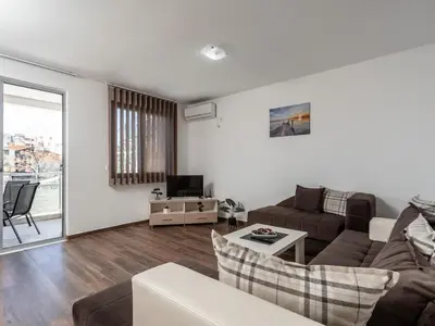 a living room with a couch and a table at Apartments 4U in Dobra Voda