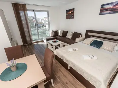 a living room with two beds and a couch at Apartments 4U in Dobra Voda