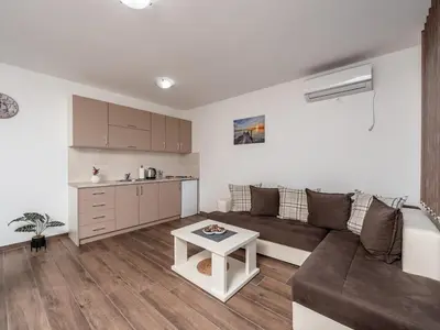 a living room with a couch and a table at Apartments 4U in Dobra Voda