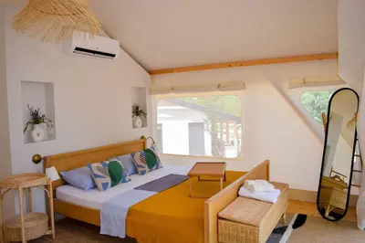 a bedroom with a bed and a window at Oblun Eco Resort - New Glamping Tents near Lake Skadar in Podgorica