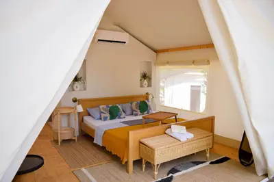 a bedroom with a bed and a window at Oblun Eco Resort - New Glamping Tents near Lake Skadar in Podgorica