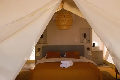 a bedroom with a bed in a tent at Oblun Eco Resort - New Glamping Tents near Lake Skadar in Podgorica