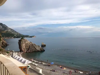 a view of a beach with people in the water at Adrian in Rafailovici