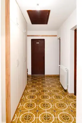 an empty hallway with a door and a tile floor at Apartment Busola in Kotor