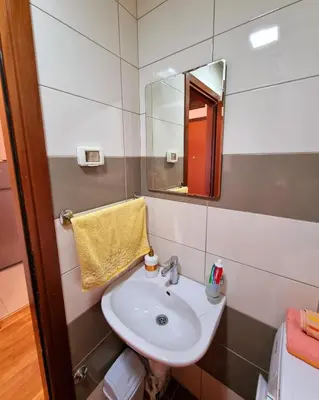 a bathroom with a sink and a mirror at Studio apartment Vito in Podgorica